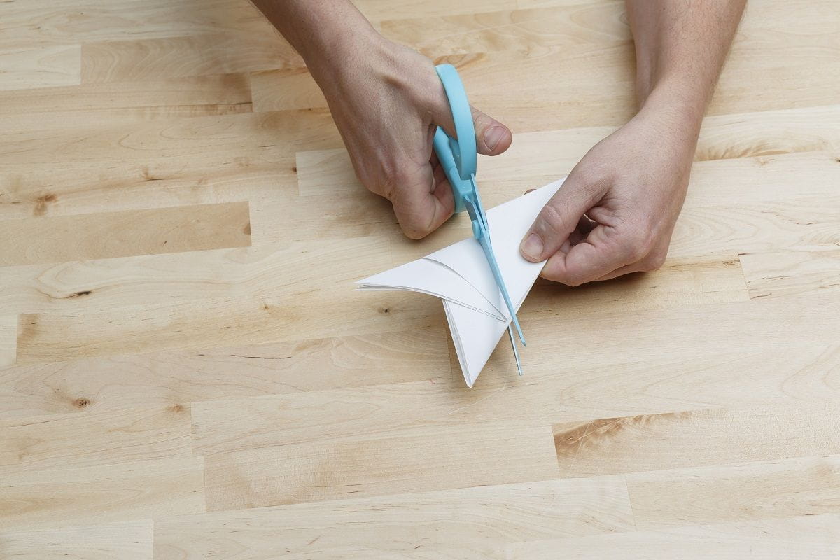 step 5 cutting into paper plane with scissors