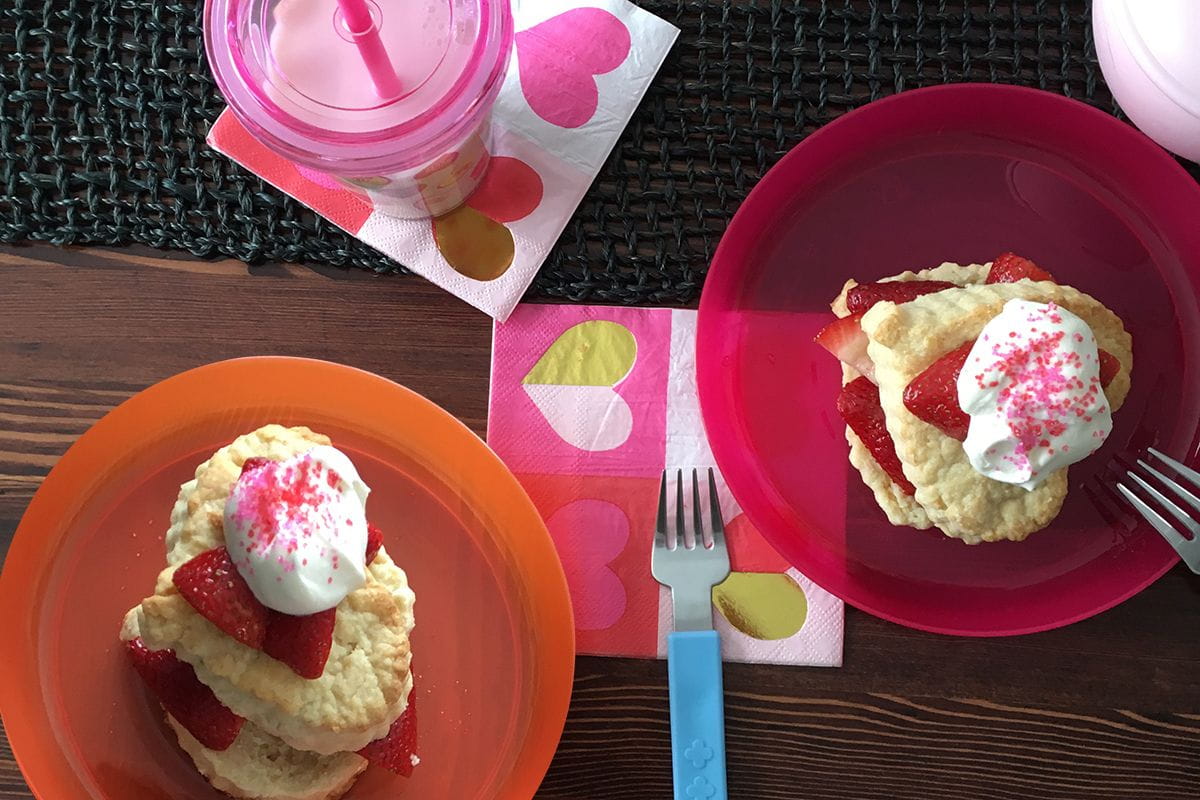 overhead heart-shaped strawberry shortcakes table setup