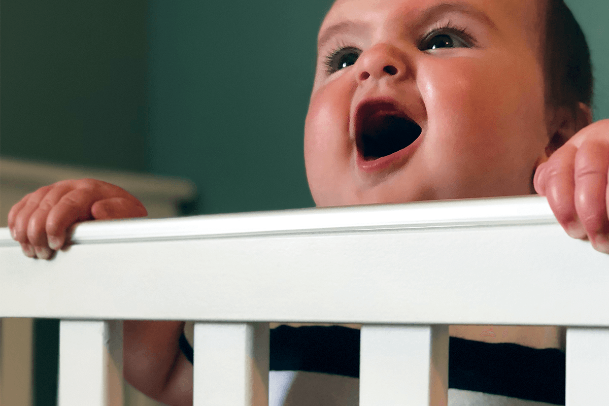 Happy baby in crib