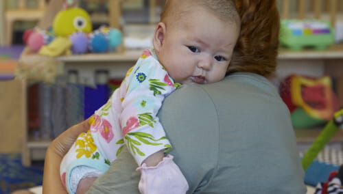 teacher holding infant