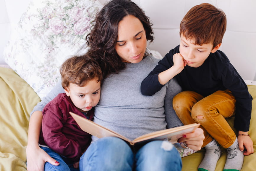 Mom and two boys reading 