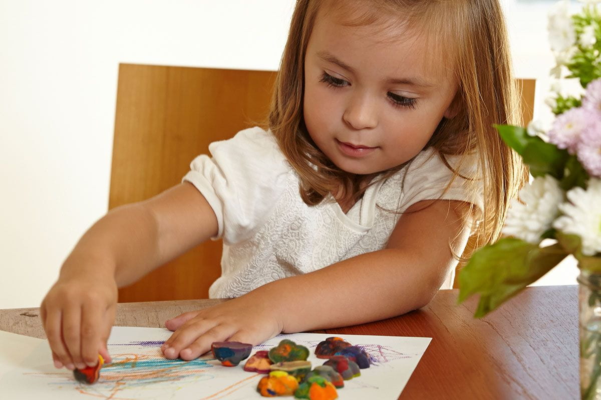 little girl using coolest crayon