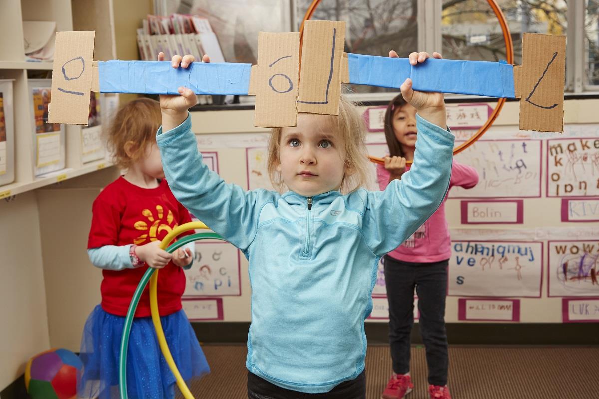 little girl looking at barbells