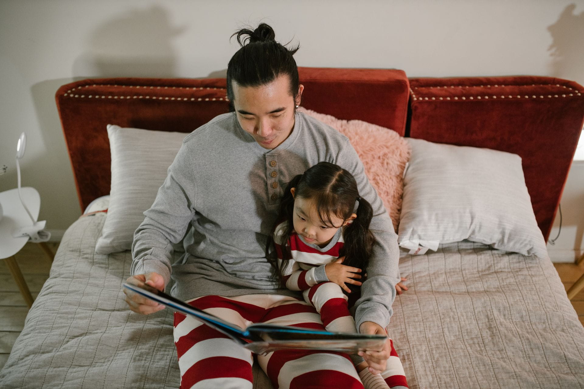 Father and daughter reading a bedtime story together, fostering bonding and family time