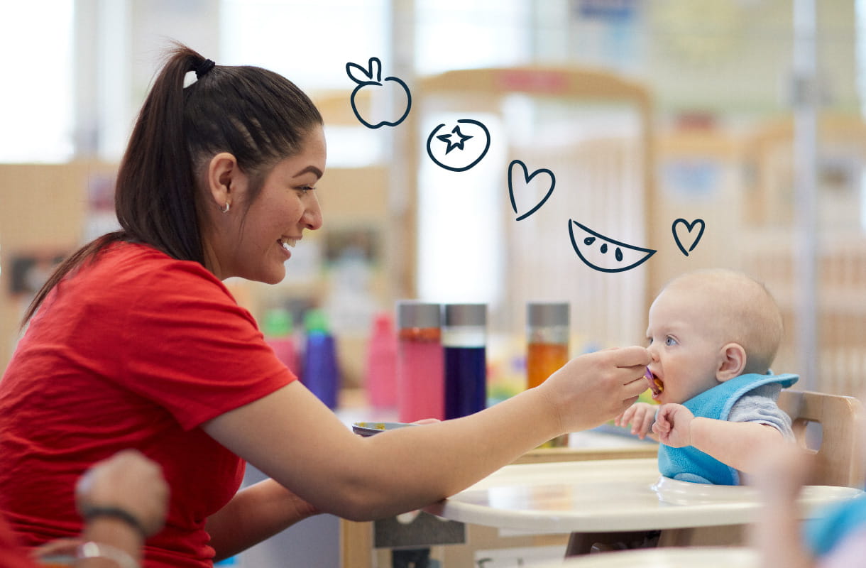 teacher spoon feeding infant