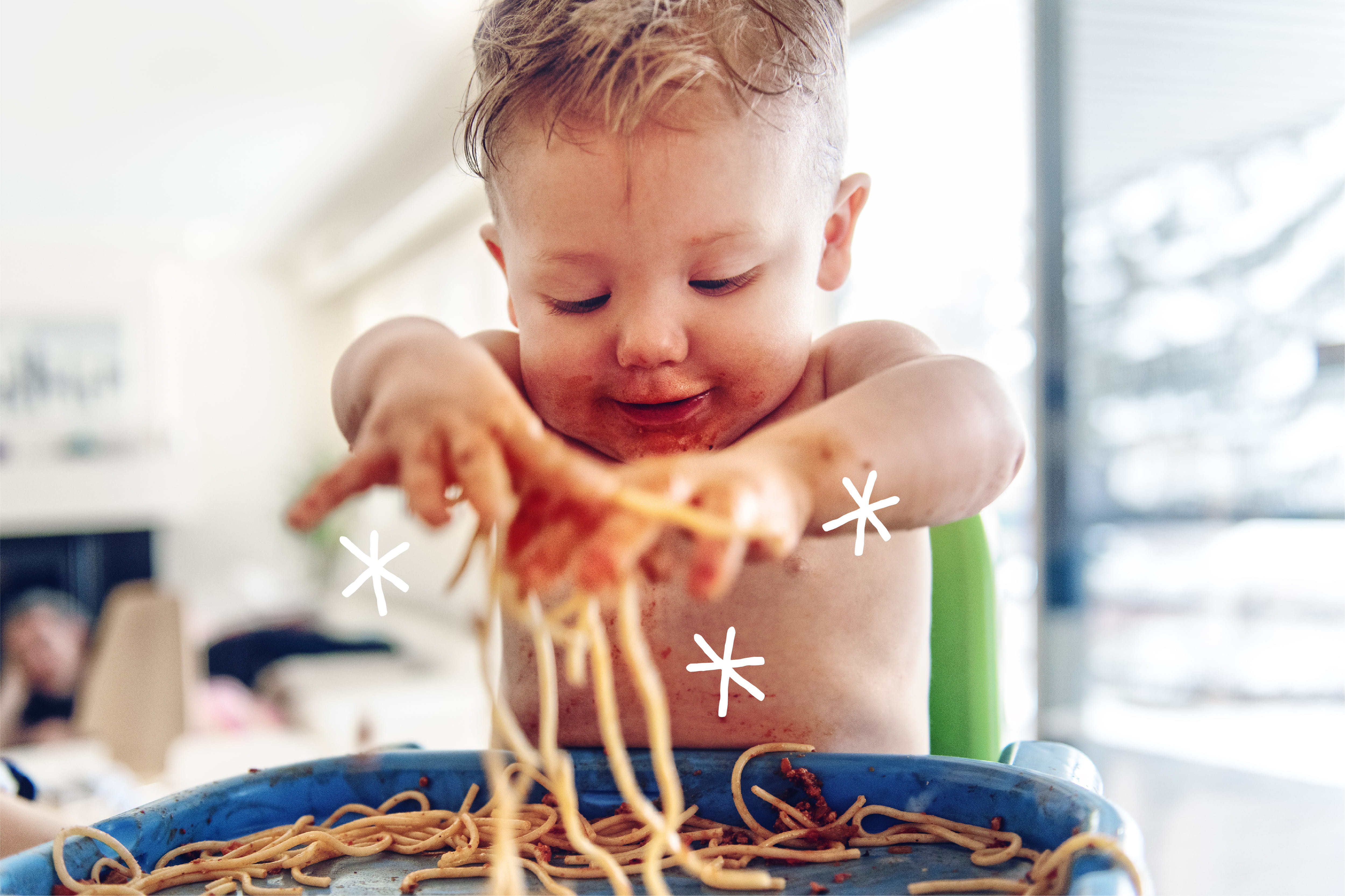 boy playing with spaghetti