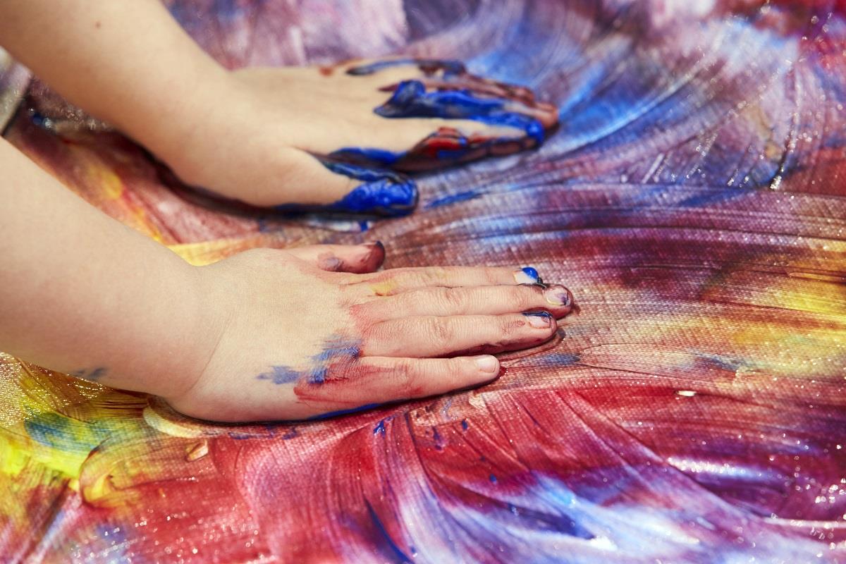 making color swirls with paint and hands