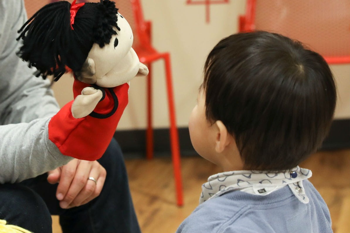 boy looking at puppet
