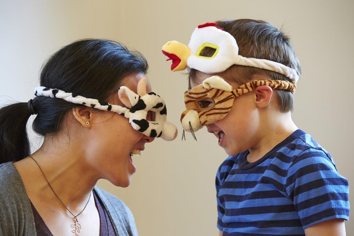 mom and child being silly with animal masks