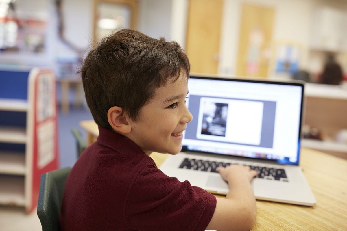 young-boy-smiling-laptop-online-safety