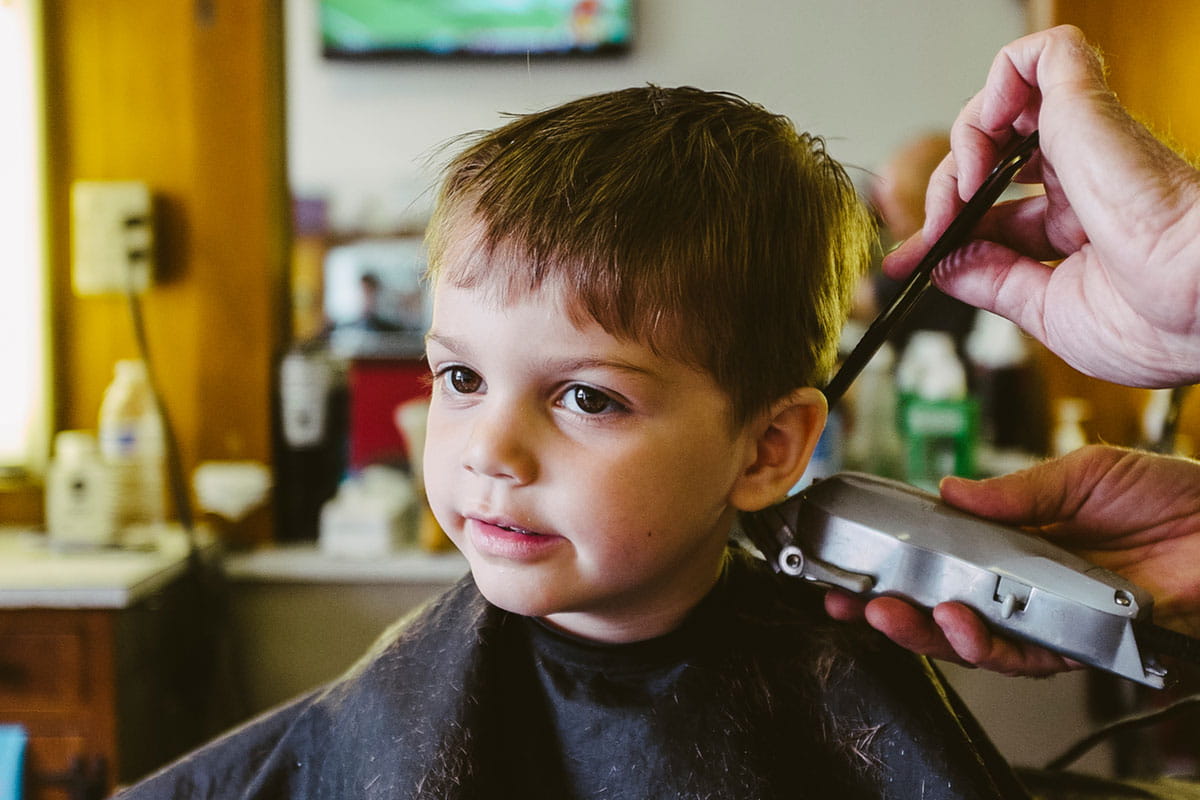 Toddler boy getting hair cut. Photo by Cameron Whitman/Stocksy United