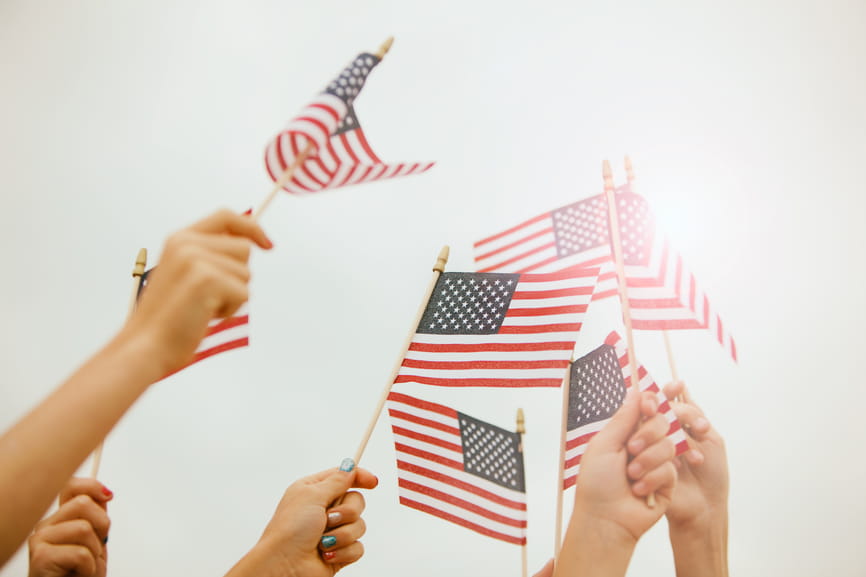 Hands holding American flags