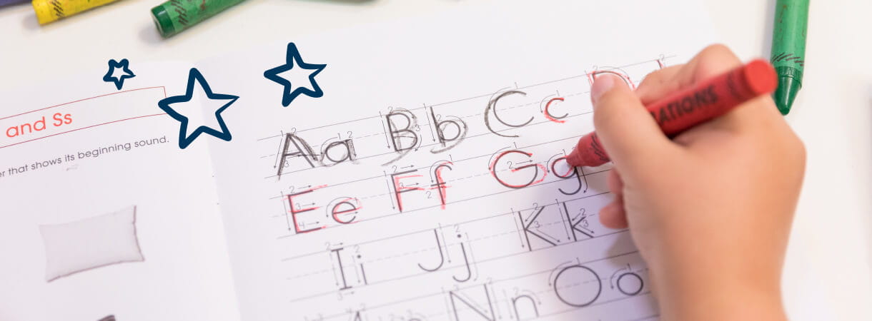 Child writing ABC's