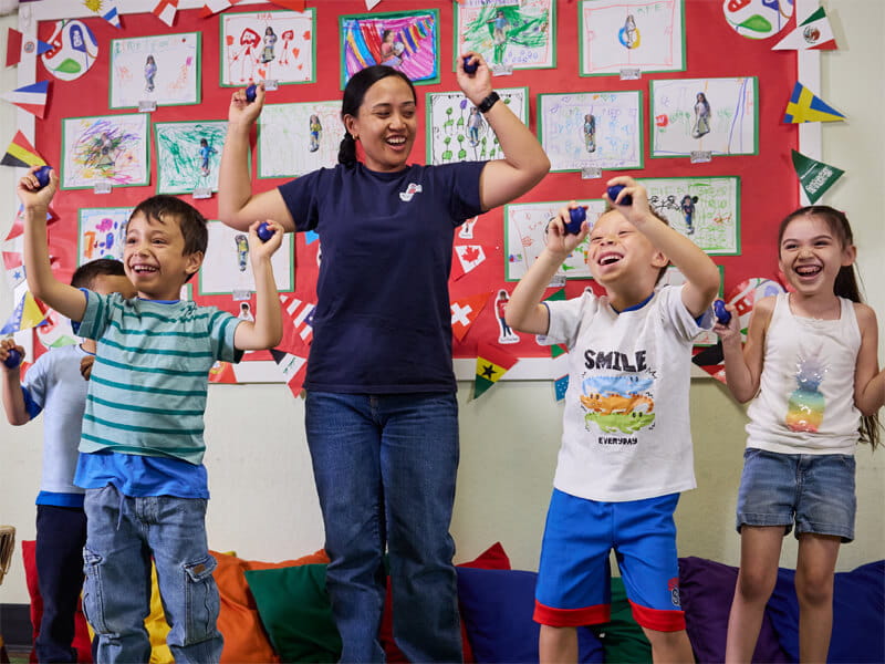 Prekindergarten kids dancing with teacher in the prek classroom