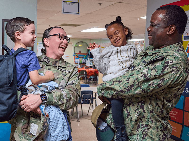 military parents dropping children off at daycare