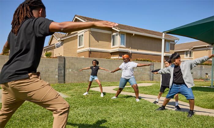 teacher teaching yoga to kids