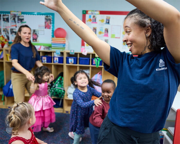 teacher dancing in classroom with toddlers