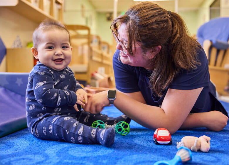 teacher with infant in classroom