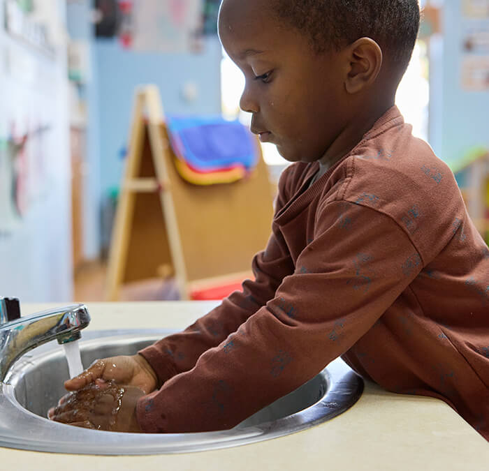 Boy washing his hands at daycare