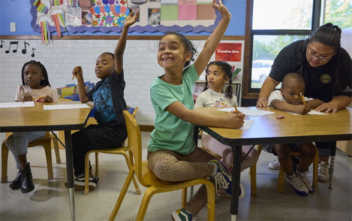 kindergarteners raising hands