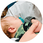 infant sleeping in arms