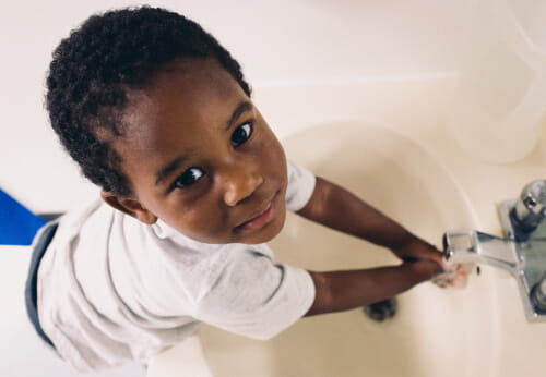 child washing hands