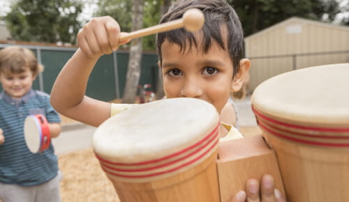 boy playing bongos