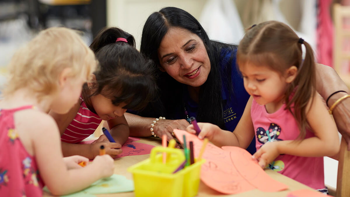 teacher with students at table