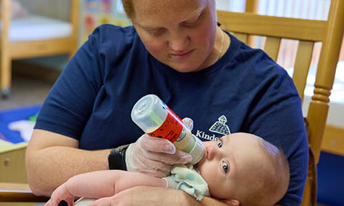 teacher feeding infant