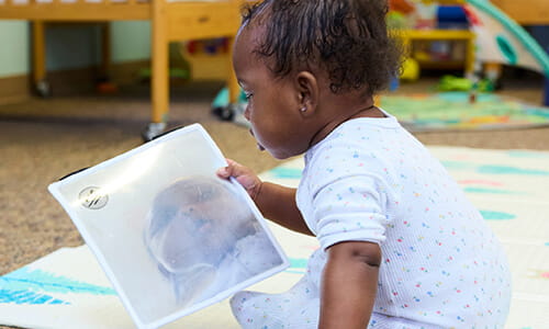 infant reading a book