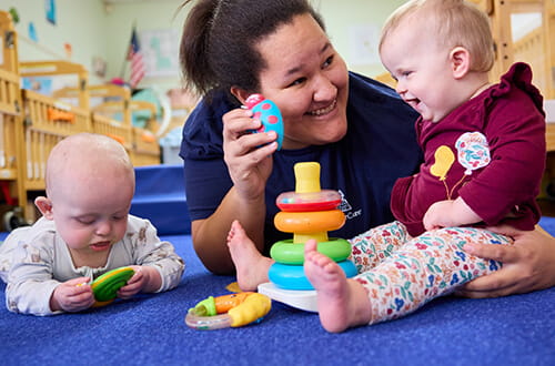 teacher playing with infant