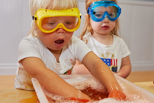 toddlers doing a science experiment