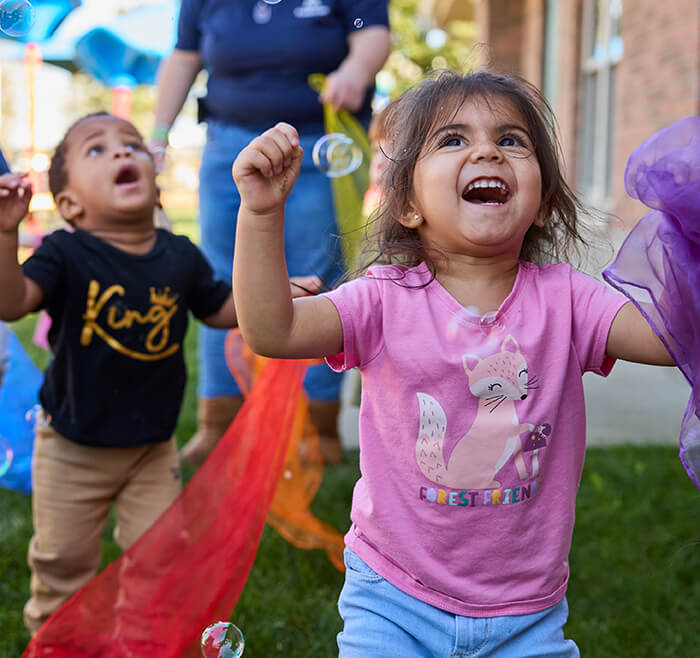 kids playing with bubbles outside